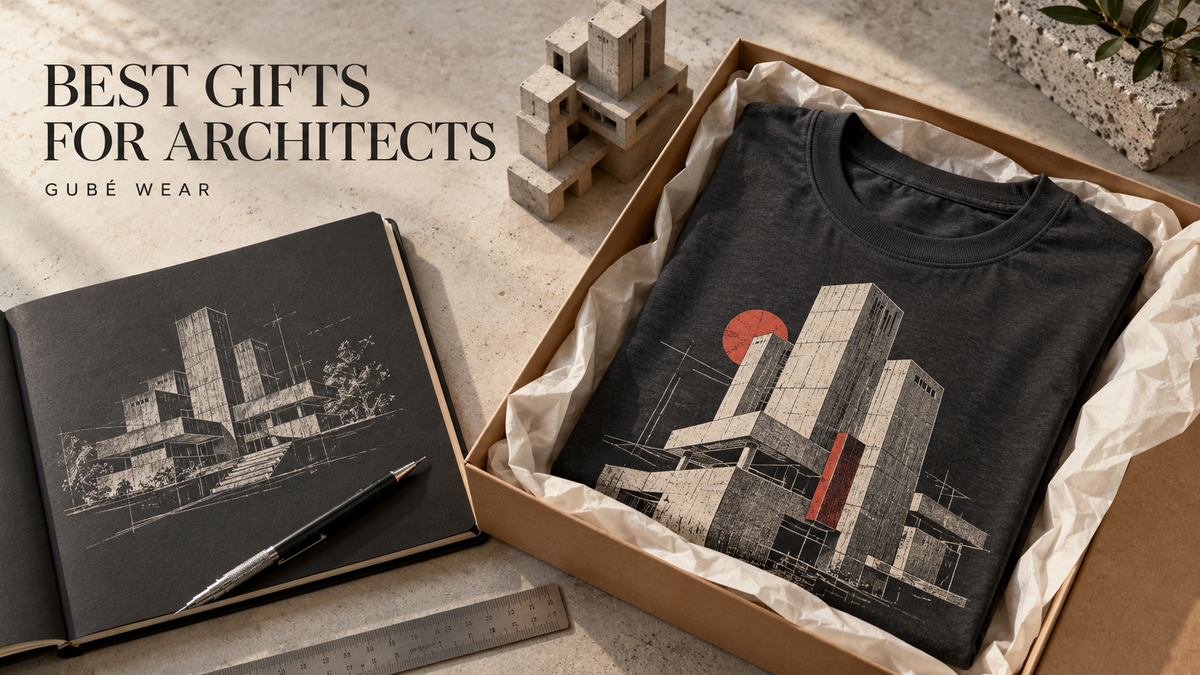 Architectural graphic T-shirt in a gift box beside a sketchbook and concrete building model.